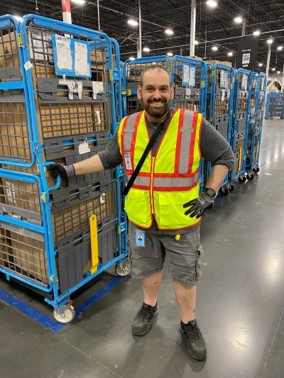 Rob Atalla standing next to a row of go-carts