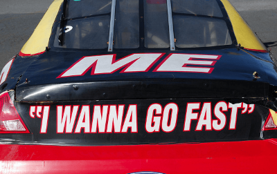 rear end of a car that says 'I wanna go fast'